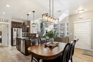 Dining space with sink and light wood-type flooring