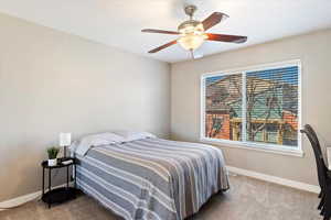 Bedroom featuring carpet and ceiling fan