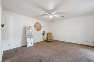 Interior space featuring carpet floors and ceiling fan