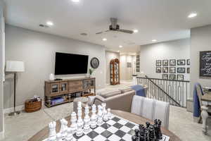 Living room with light colored carpet and ceiling fan