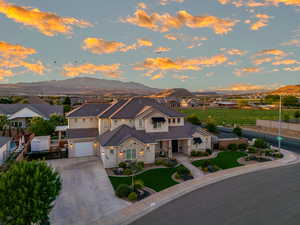 View of front of property with a garage and a mountain view