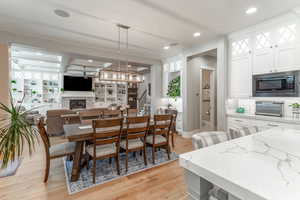 Dining room with beam ceiling and light hardwood / wood-style floors