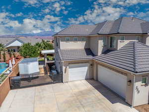 View of front facade featuring a garage and a mountain view