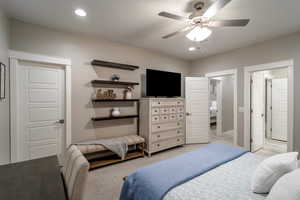 Bedroom featuring ceiling fan and light colored carpet