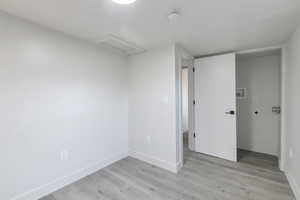 Unfurnished room featuring light wood-type flooring