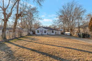 Single story home featuring a front lawn