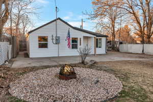 Rear view of property featuring an outdoor fire pit and a patio