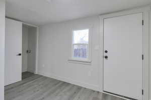 Foyer with light hardwood / wood-style flooring