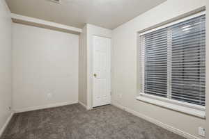 Unfurnished bedroom featuring a closet and carpet flooring