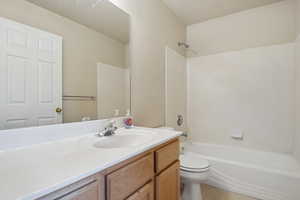 Full bathroom featuring toilet, vanity, and  shower combination