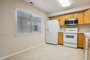 Kitchen featuring white appliances