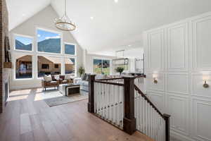 Interior space featuring an inviting chandelier, high vaulted ceiling, and hardwood / wood-style floors