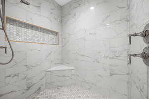 Bathroom featuring a tile shower