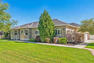 View of front of property with a garage and a front yard