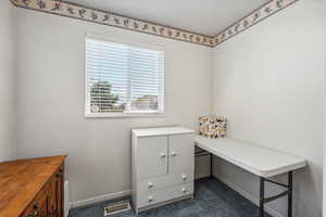 Office featuring dark colored carpet