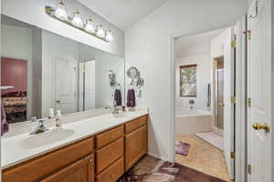 Bathroom with vanity, plus walk in shower, and tile patterned flooring