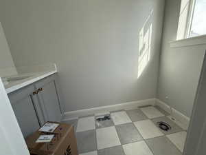 Laundry area with baseboards and a sink