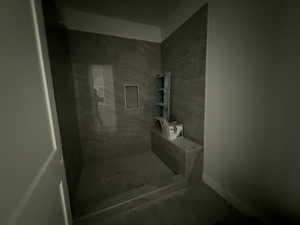 Full bath featuring tiled shower