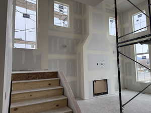 Staircase with a towering ceiling