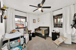 Carpeted bedroom with ceiling fan