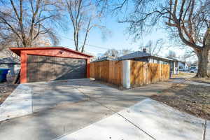 View of side of property featuring a garage and an outdoor structure