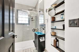 Bathroom featuring an enclosed shower and vanity