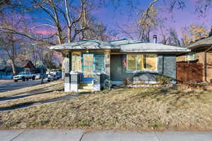 View of front of home featuring a yard and a porch