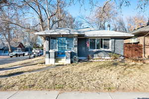 View of front facade with covered porch and a front lawn