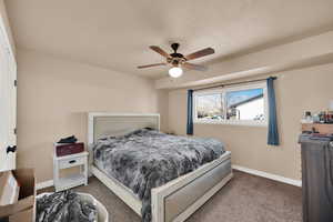 Bedroom featuring ceiling fan and carpet