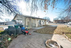 Rear view of house featuring a fire pit and a patio