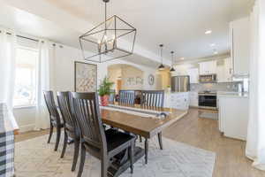 Dining room featuring a chandelier, sink, and light wood-type flooring