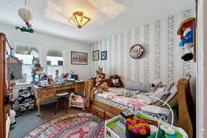 Bedroom with carpet floors and a textured ceiling