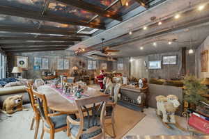 Dining area featuring rail lighting, a wealth of natural light, and ceiling fan