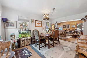 Dining area with a notable chandelier and light wood-type flooring