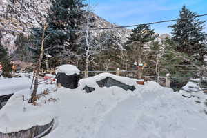 Yard covered in snow with a mountain view