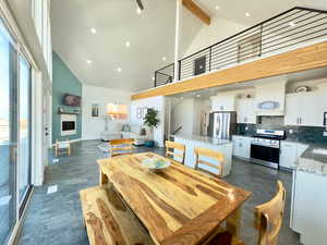 Dining space featuring high vaulted ceiling