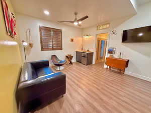 Bedroom/family room featuring light hardwood / wood-style floors and ceiling fan