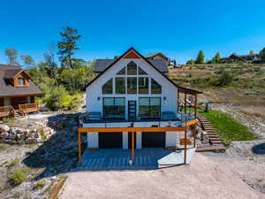 View of property with a deck and a garage