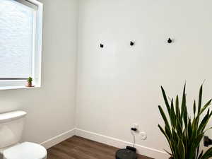 Bathroom with LVP flooring, a wealth of natural light, and toilet