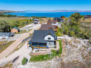 Drone / aerial view featuring a water and mountain view