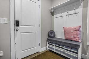 Mudroom featuring dark hardwood / wood-style flooring- You can add a door to seperate the basement future apartment from the main level if desired.