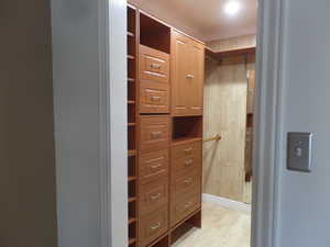 Owners Spacious Walk-In Closet with Custom Built-Ins