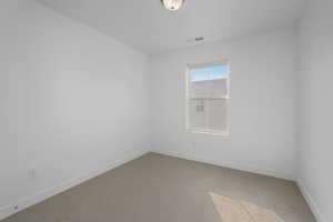 Unfurnished room with carpet