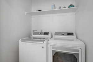 Clothes washing area featuring washing machine and dryer