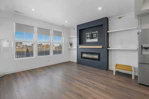 Unfurnished living room with hardwood / wood-style floors and a fireplace