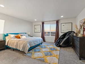 Bedroom with light colored carpet and a textured ceiling