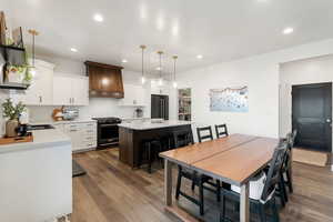 Dining space with dark hardwood / wood-style floors and sink