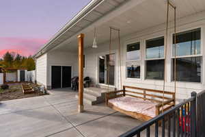 Patio terrace at dusk featuring grilling area