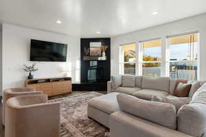 Living room featuring hardwood / wood-style floors and a large fireplace