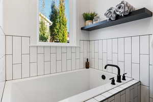 Owners bathroom with a relaxing tiled tub